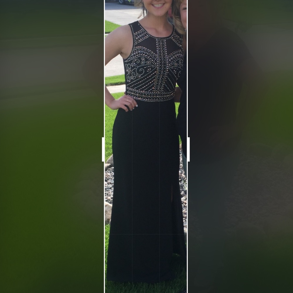 Floor length prom dress. Sheer back with a slit.